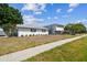 A quaint two-story home with a beautifully maintained lawn and mature trees at 8413 Lopez Dr, Tampa, FL 33615