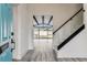 Inviting home foyer with staircase and glimpse of the backyard pool at 8413 Lopez Dr, Tampa, FL 33615