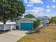 Two-story home with a bright blue garage door and well-maintained landscaping at 8413 Lopez Dr, Tampa, FL 33615