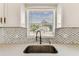 Kitchen details show backsplash, quartz counters and stainless faucet at 8413 Lopez Dr, Tampa, FL 33615