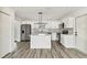 Spacious kitchen features stainless appliances, white cabinets and a center island at 8413 Lopez Dr, Tampa, FL 33615