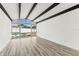 Bright living space featuring vaulted ceiling with wood beams, and wood-look floors at 8413 Lopez Dr, Tampa, FL 33615
