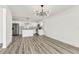 Bright, airy open-concept living space with kitchen and wood-look floors at 8413 Lopez Dr, Tampa, FL 33615