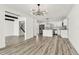 Bright open-concept living space with modern kitchen and stylish decor and wood-look floors at 8413 Lopez Dr, Tampa, FL 33615