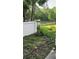 Tranquil backyard view of pond with lush greenery and privacy wall in a well-maintained community at 8423 Edgewater Place Blvd, Tampa, FL 33615