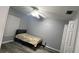 Bedroom with gray walls, ceiling fan, bed, and a window at 8423 Edgewater Place Blvd, Tampa, FL 33615