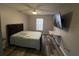Bedroom featuring modern furniture, a mounted TV, and neutral wall color at 8423 Edgewater Place Blvd, Tampa, FL 33615