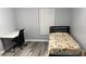 This bedroom offers a desk and neutral colors with laminate flooring at 8423 Edgewater Place Blvd, Tampa, FL 33615