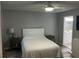 Bedroom featuring a ceiling fan, neutral wall color, and an ensuite bathroom at 8423 Edgewater Place Blvd, Tampa, FL 33615