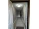 View through doorway of long, gray hallway with white trim and ceiling light at 8423 Edgewater Place Blvd, Tampa, FL 33615