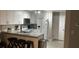 This kitchen features a breakfast bar with seating, granite countertops and white cabinetry at 8423 Edgewater Place Blvd, Tampa, FL 33615