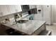 The modern kitchen boasts granite countertops, a stainless steel sink, and matching appliances at 8423 Edgewater Place Blvd, Tampa, FL 33615