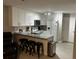 Bright kitchen features white cabinets, stainless appliances, granite countertops, and breakfast bar seating at 8423 Edgewater Place Blvd, Tampa, FL 33615