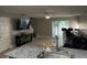 Open concept living room, with a ceiling fan, sliding door, and tile flooring throughout the area at 8423 Edgewater Place Blvd, Tampa, FL 33615