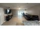 This living room offers tile floors, access to the outside, and a mounted TV at 8423 Edgewater Place Blvd, Tampa, FL 33615
