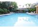 Community pool with lounge chairs, shaded seating areas, and well-maintained landscaping at 8423 Edgewater Place Blvd, Tampa, FL 33615