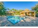 Community pool surrounded by lush landscaping, lounge chairs, and covered seating at 8423 Edgewater Place Blvd, Tampa, FL 33615