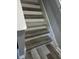 Staircase showcasing laminate wood steps with white risers and stringers at 8423 Edgewater Place Blvd, Tampa, FL 33615