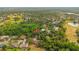 Beautiful aerial view of a neighborhood featuring mature trees and well-maintained homes with lush green surroundings at 9107 Spring Hill Dr, Spring Hill, FL 34608