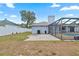 Spacious backyard featuring a patio, fenced yard, and screened-in pool at 9107 Spring Hill Dr, Spring Hill, FL 34608