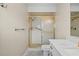 Updated bathroom showcasing a sleek vanity, tiled flooring, and a shower with a gold frame at 9107 Spring Hill Dr, Spring Hill, FL 34608