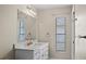 Bright bathroom featuring a white vanity with a marble countertop and modern fixtures at 9107 Spring Hill Dr, Spring Hill, FL 34608