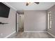 Bedroom with ceiling fan, laminate flooring, and a small window at 9107 Spring Hill Dr, Spring Hill, FL 34608