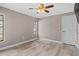 Cozy bedroom with a ceiling fan and updated flooring at 9107 Spring Hill Dr, Spring Hill, FL 34608