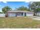 Inviting single-story home with a two-car garage and a nicely landscaped front yard at 9107 Spring Hill Dr, Spring Hill, FL 34608