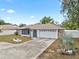 Charming single-story home with a two-car garage and a well-kept front lawn at 9107 Spring Hill Dr, Spring Hill, FL 34608