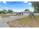 Well-maintained single-story home with a two-car garage and a manicured front yard at 9107 Spring Hill Dr, Spring Hill, FL 34608