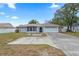Attractive single-story home featuring a two-car garage and nicely landscaped front yard at 9107 Spring Hill Dr, Spring Hill, FL 34608