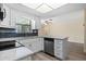 Bright kitchen with stainless appliances, granite countertops, white cabinetry, and direct access to the living area at 9107 Spring Hill Dr, Spring Hill, FL 34608