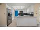 Kitchen featuring white cabinets, stainless fridge, breakfast bar, and stylish backsplash at 9107 Spring Hill Dr, Spring Hill, FL 34608