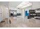 Bright kitchen featuring stainless steel appliances, white cabinetry, granite countertops and blue tile backsplash at 9107 Spring Hill Dr, Spring Hill, FL 34608