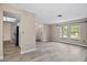 Inviting living room with light flooring and ample natural light, next to entry and kitchen at 9107 Spring Hill Dr, Spring Hill, FL 34608