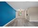 Bright living room with a vibrant blue accent wall and modern, light-colored flooring at 9107 Spring Hill Dr, Spring Hill, FL 34608