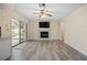 Open living room featuring kitchen access, pool views, and laminate flooring at 9107 Spring Hill Dr, Spring Hill, FL 34608