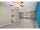 Spacious living room with wood-look flooring, a ceiling fan, and natural light at 9107 Spring Hill Dr, Spring Hill, FL 34608