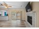 Bright living room featuring fireplace, new floors, and backyard access at 9107 Spring Hill Dr, Spring Hill, FL 34608