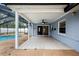 Covered patio with tiled floor, ceiling fan, and sliding door access to the interior at 9107 Spring Hill Dr, Spring Hill, FL 34608