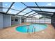 Backyard pool with screened-in enclosure, offering a private and enjoyable outdoor space for swimming and relaxation at 9107 Spring Hill Dr, Spring Hill, FL 34608