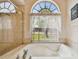 Bright bathroom features a soaking tub with a window view and a separate shower at 9219 Irondale Ln, Hudson, FL 34667