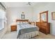 Bedroom with carpeted floors, a wooden bed frame, and traditional decor at 9219 Irondale Ln, Hudson, FL 34667