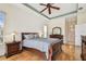 Comfortable bedroom featuring hardwood floors, classic furnishings, and ensuite bathroom access at 9219 Irondale Ln, Hudson, FL 34667