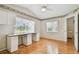 Well-lit bedroom featuring hardwood floors, a built-in desk, and a large window at 9219 Irondale Ln, Hudson, FL 34667