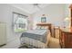 Charming bedroom with carpeted floors, a wooden bed frame, and plenty of natural light at 9219 Irondale Ln, Hudson, FL 34667