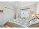 Cozy bedroom featuring a queen-sized bed, a large closet, and a view to the yard at 9219 Irondale Ln, Hudson, FL 34667