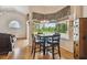 Breakfast nook with a dark wood table, seating for four, and views of the backyard at 9219 Irondale Ln, Hudson, FL 34667