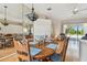 Bright dining area with hardwood floors, decorative light fixture, and easy access to the living room at 9219 Irondale Ln, Hudson, FL 34667